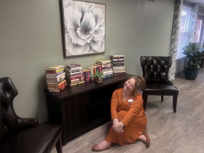 Callie Pikey, Assistant Administrator showing off our new library area.